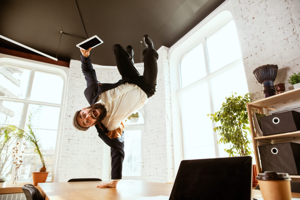 businessman having fun dancing break dance in the office at work